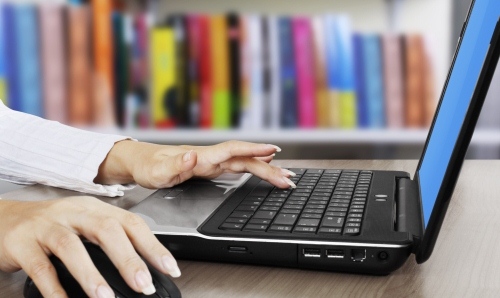 Female hands on a laptop